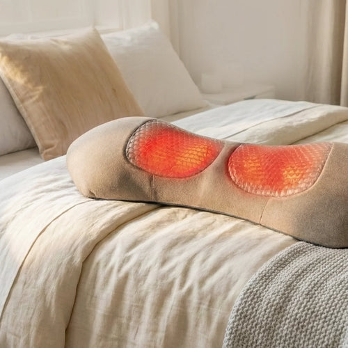 Heated cervical neck pillow with massage nodes on a bed for neck pain relief
